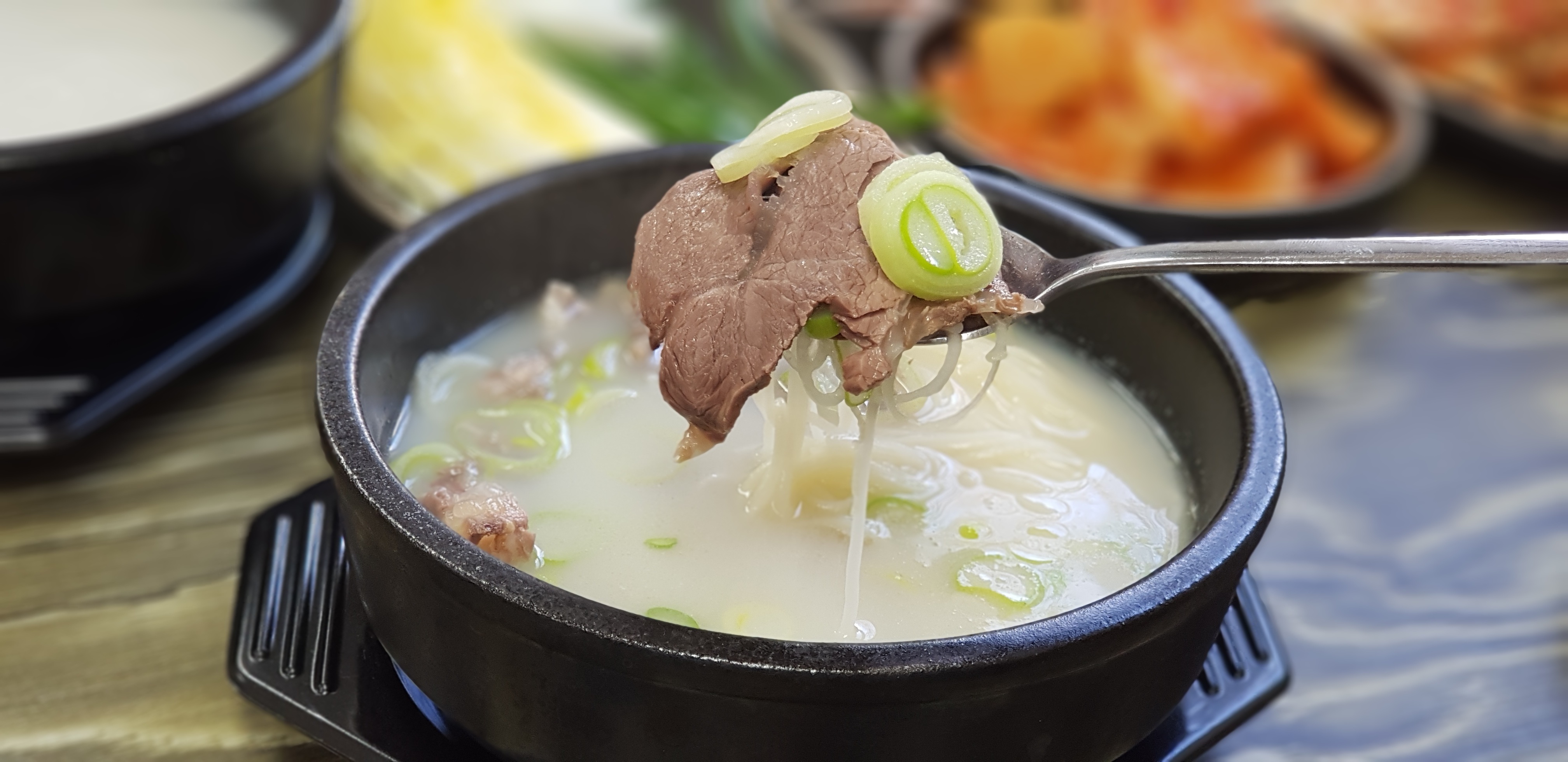 Korean ox bone soup with beef and scallions